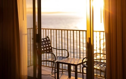 a chair and table on a balcony