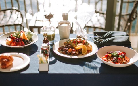 a table with plates of food and drinks