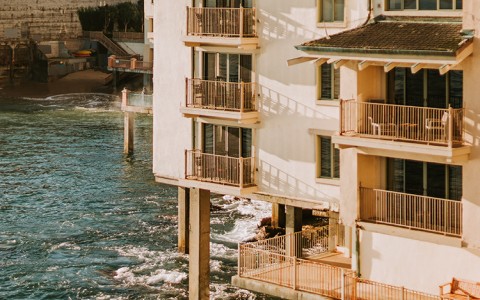 a building with balconies on the water