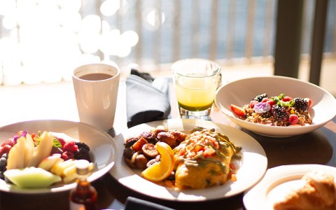 a table with plates of food and drinks