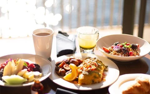 a table with plates of food and drinks