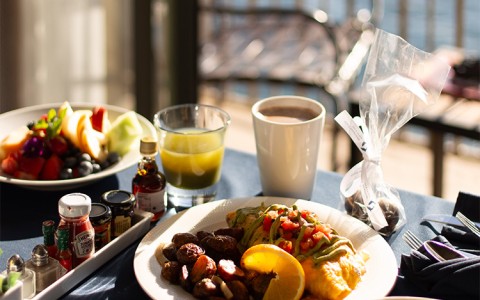 a table with plates of food and drinks