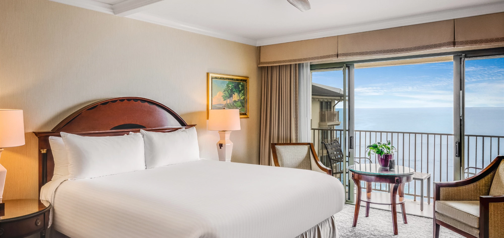 a room with a bed and chairs and a table