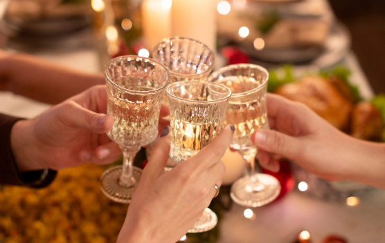 a group of hands holding wine glasses