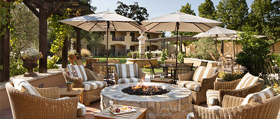 a patio with chairs and umbrellas