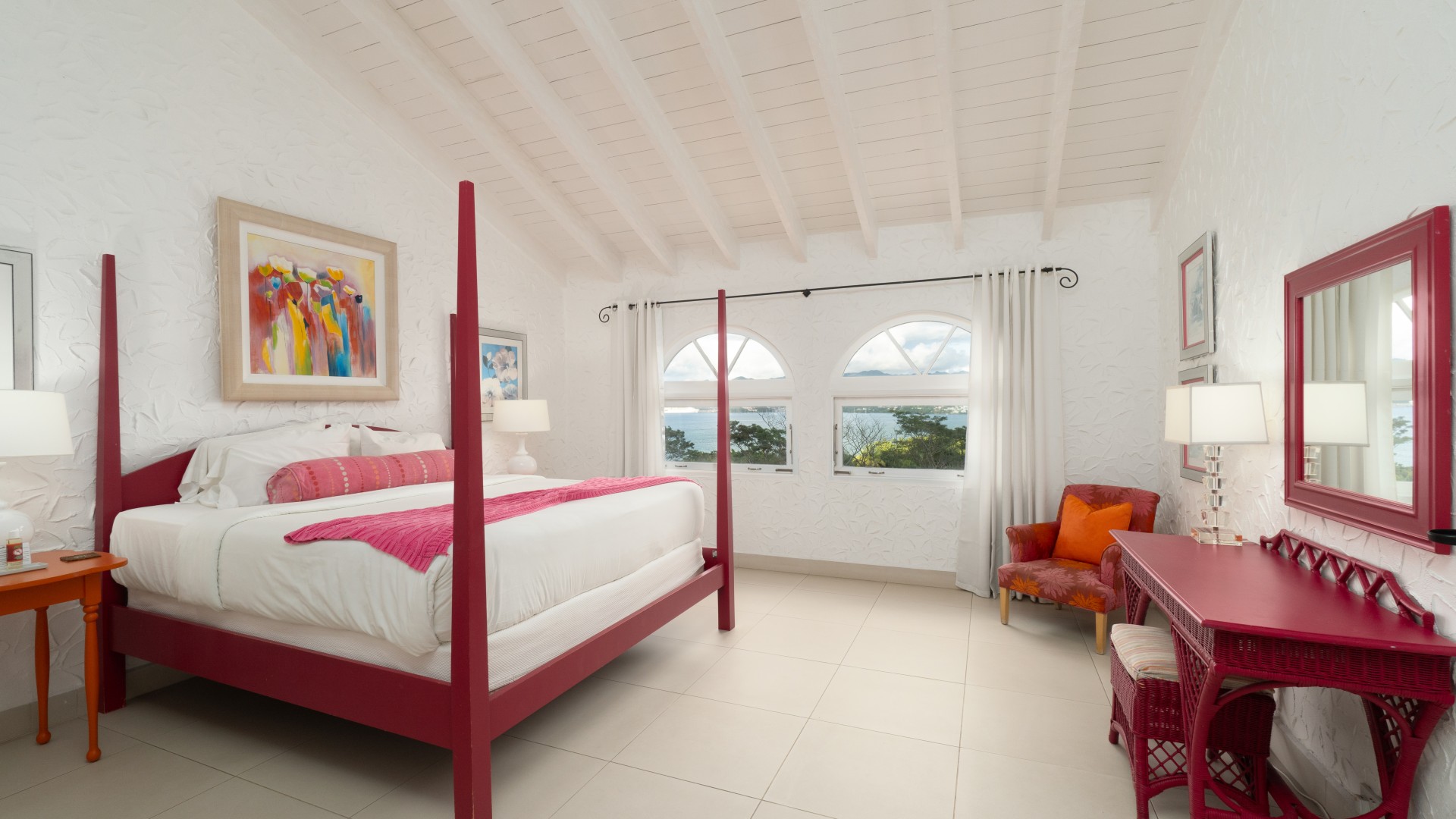 a bedroom with a bed and chairs