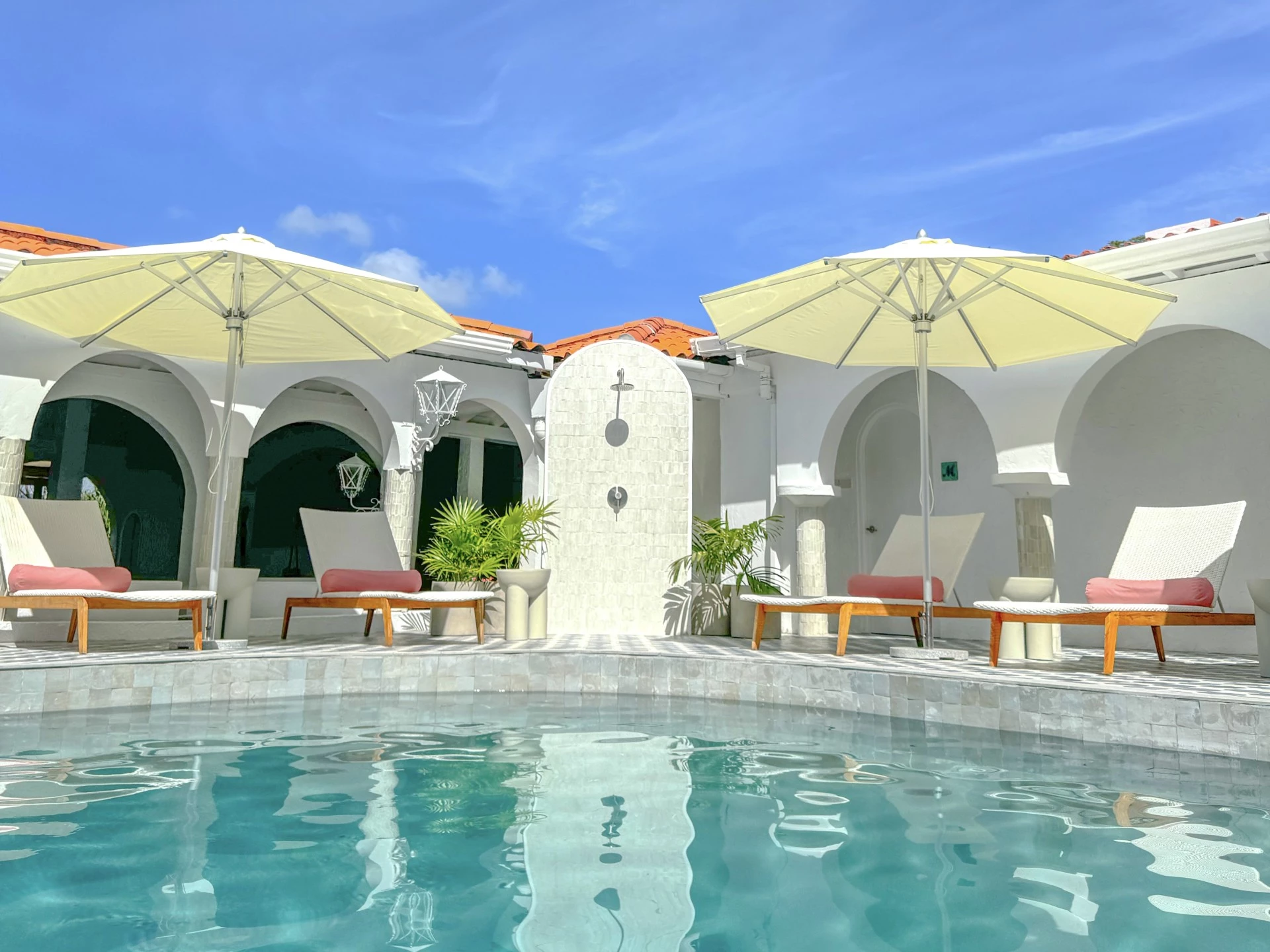 a pool with umbrellas and chairs