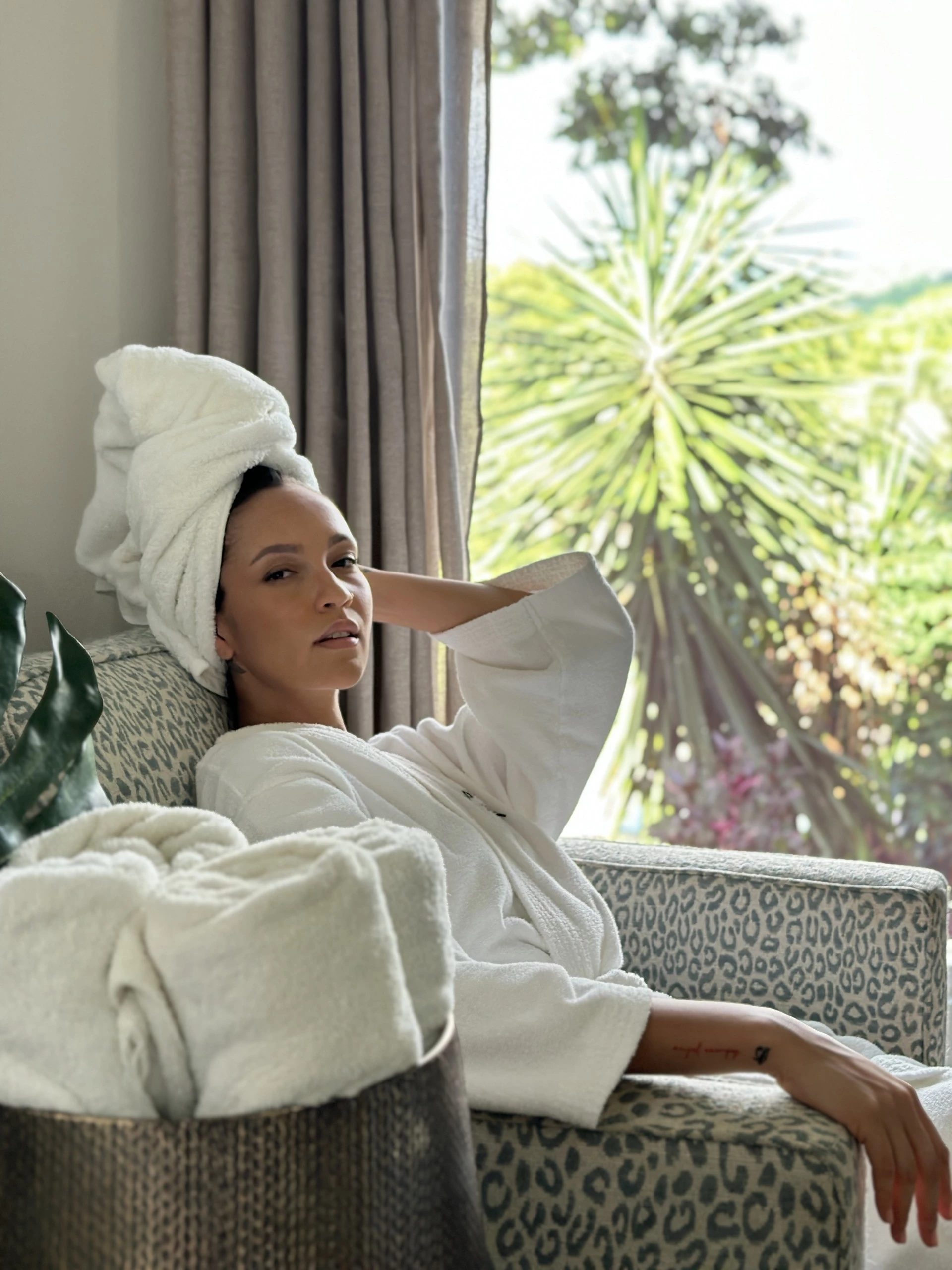 a woman in a white robe with a towel on her head