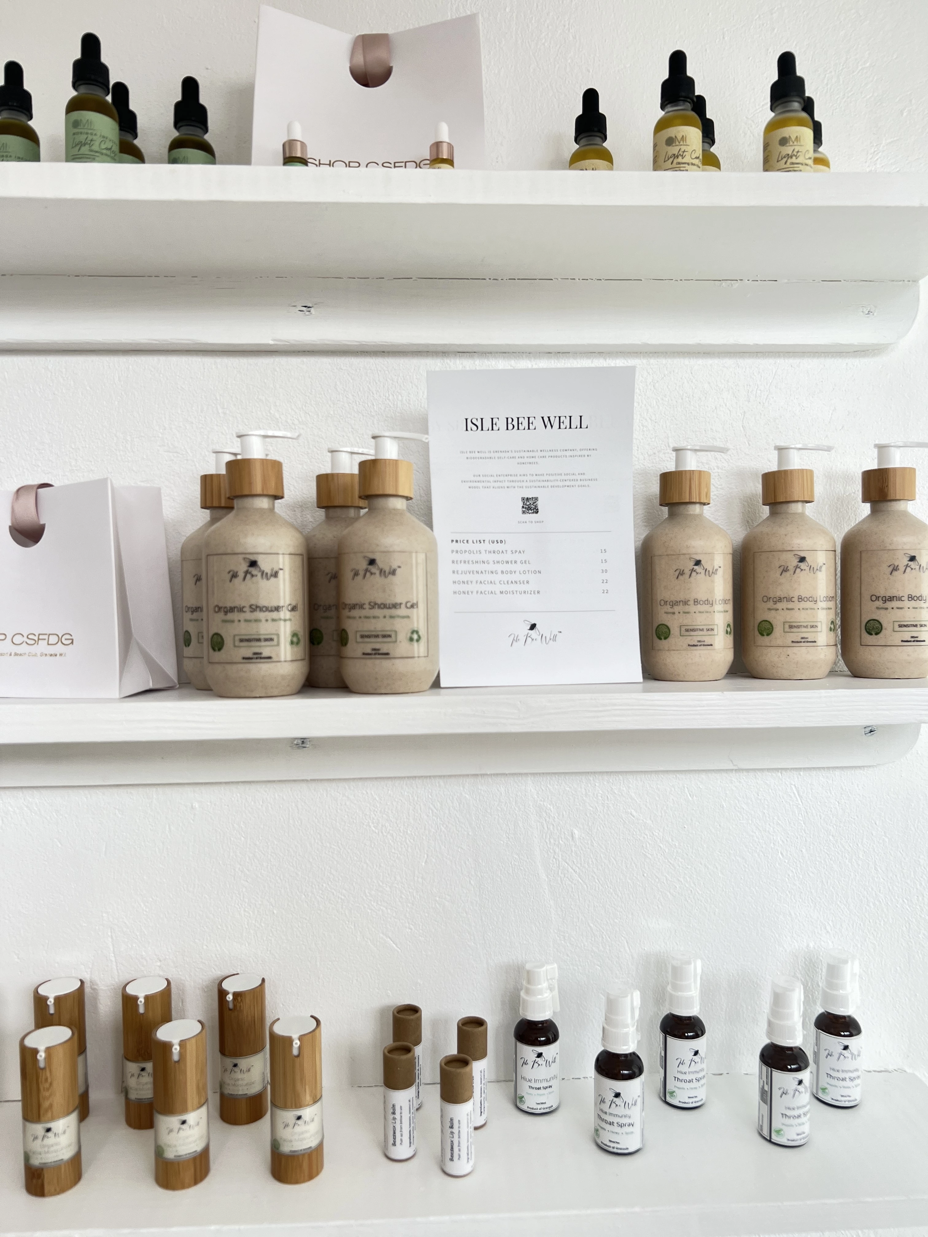 a shelf with bottles of liquid and a paper