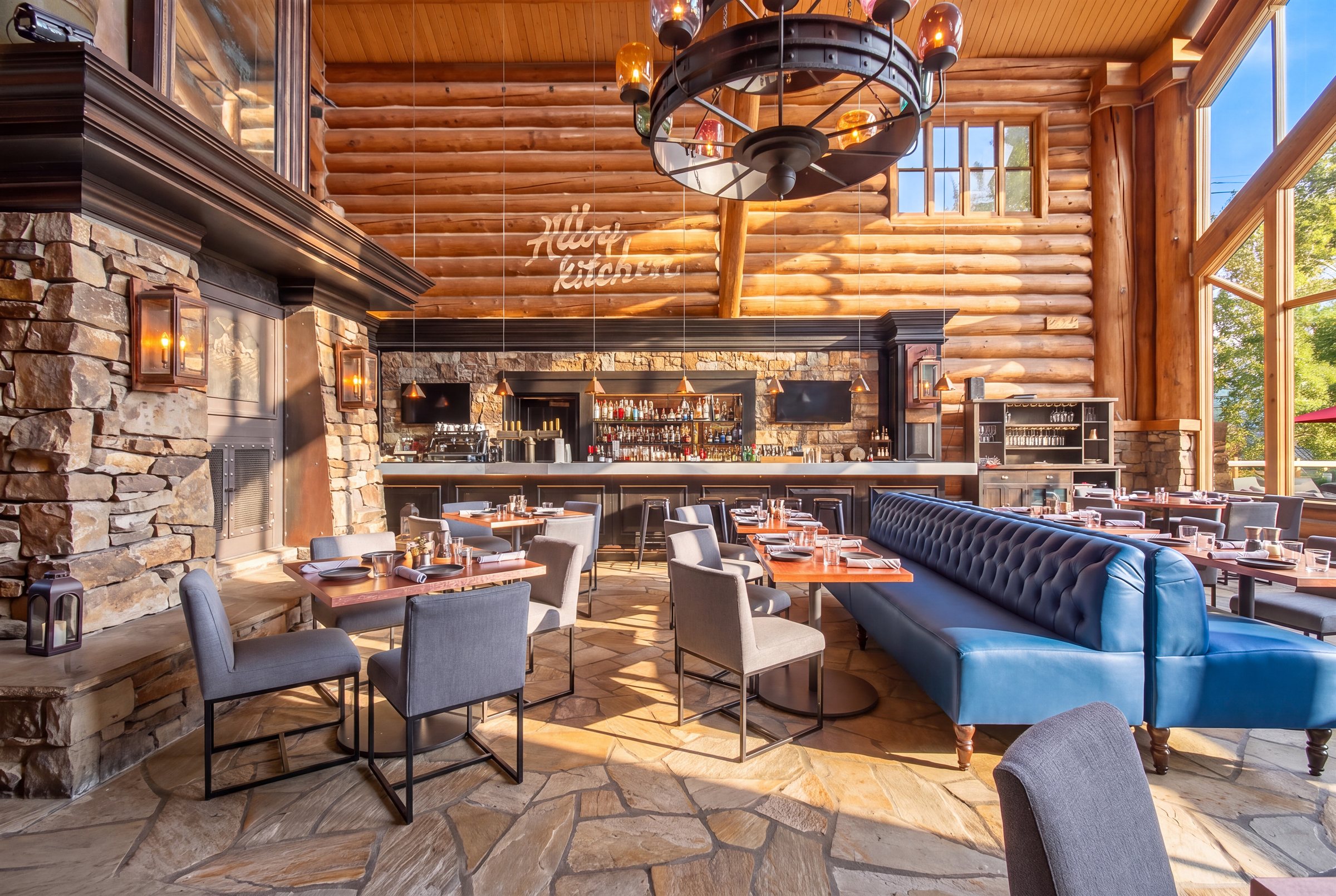 The rebuilt bar at Alloy Kitchen with blue tufted banquettes and mountain views