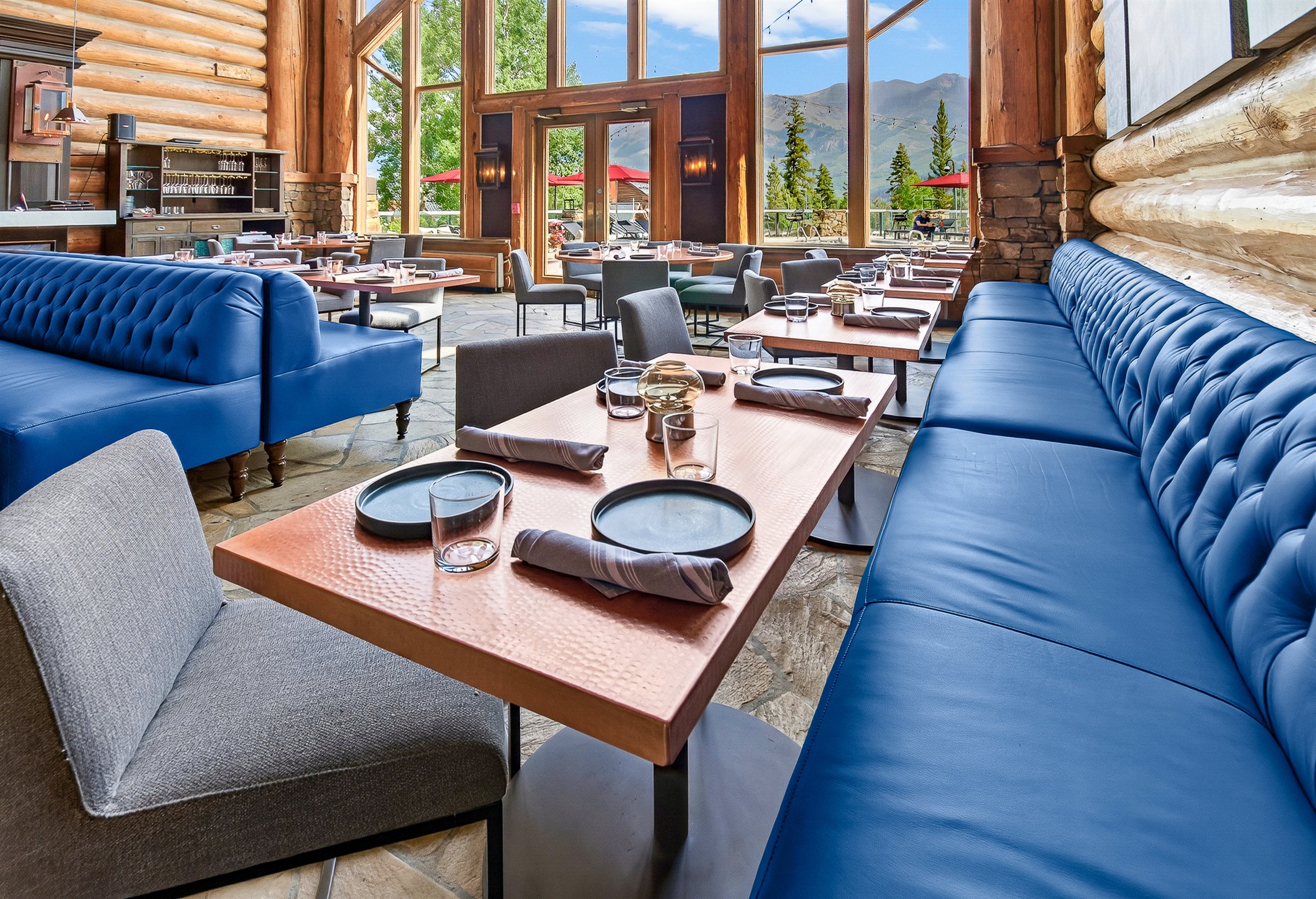 a restaurant with blue couches and tables