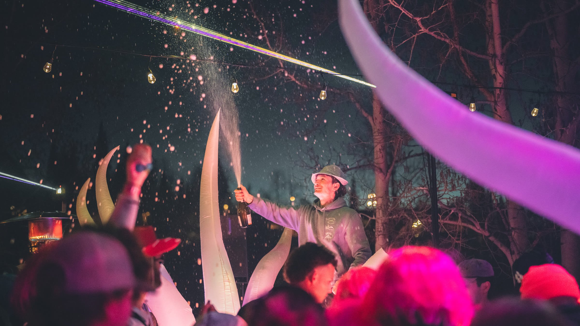DJ spraying champagne over the crowd at Après at 9,545
