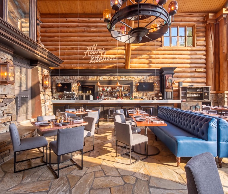 The rebuilt bar at Alloy Kitchen with blue tufted banquettes and mountain views