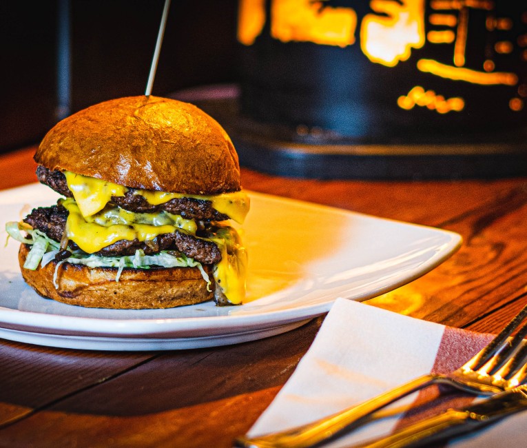 a double cheeseburger on a plate