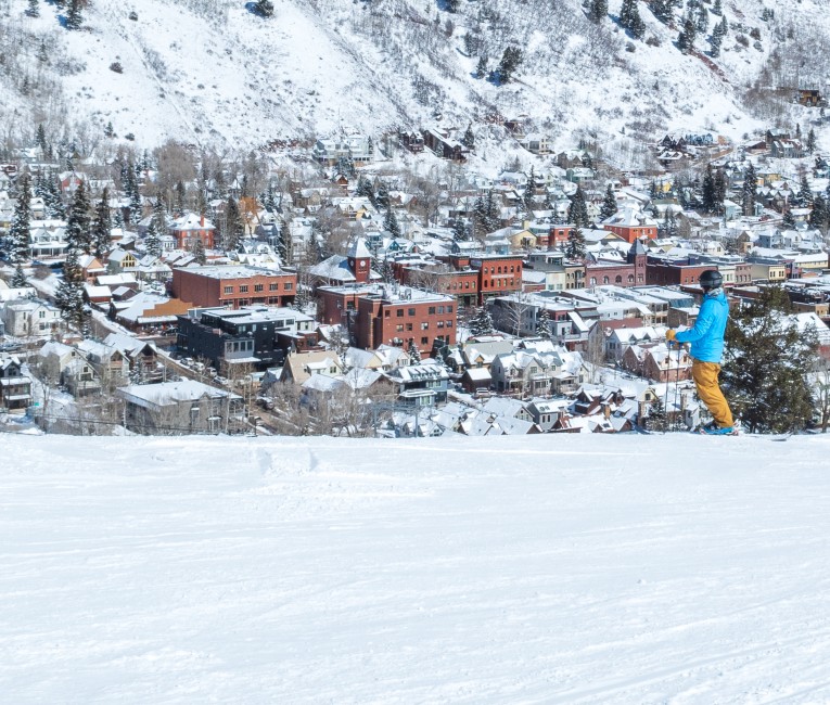 a person skiing down a hill in the snow