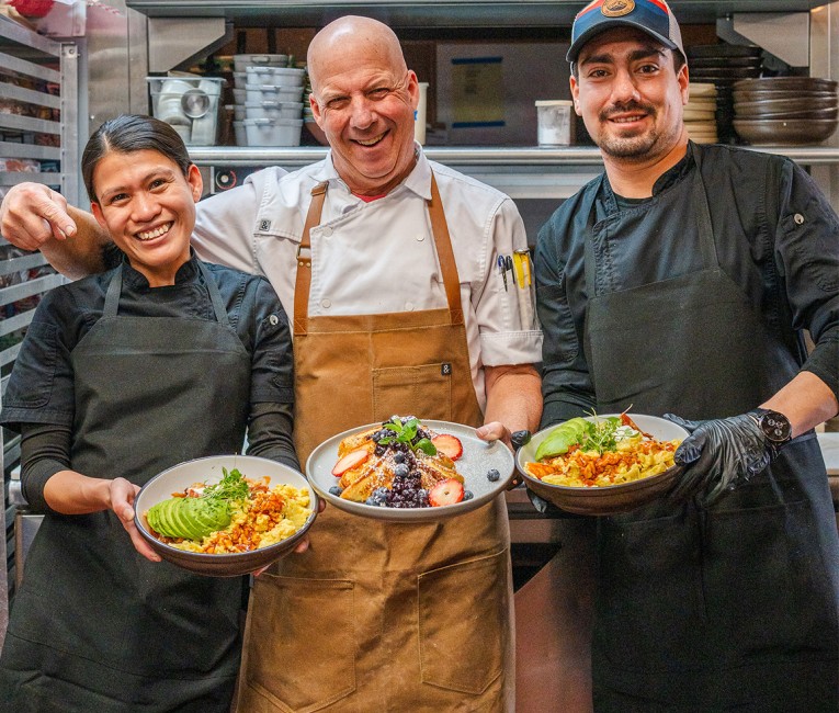a group of people holding plates of food