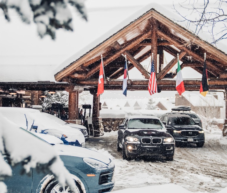 cars parked in a parking lot in the snow
