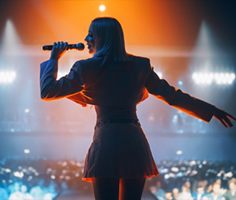 a woman singing into a microphone