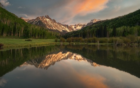 a lake with mountains in the background
