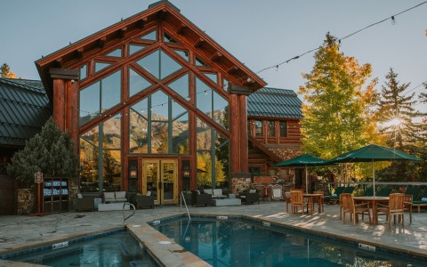 a swimming pool and a house with a mountain in the background