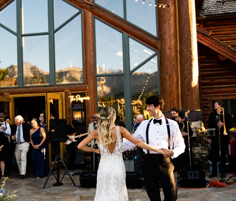 a man and woman dancing outside