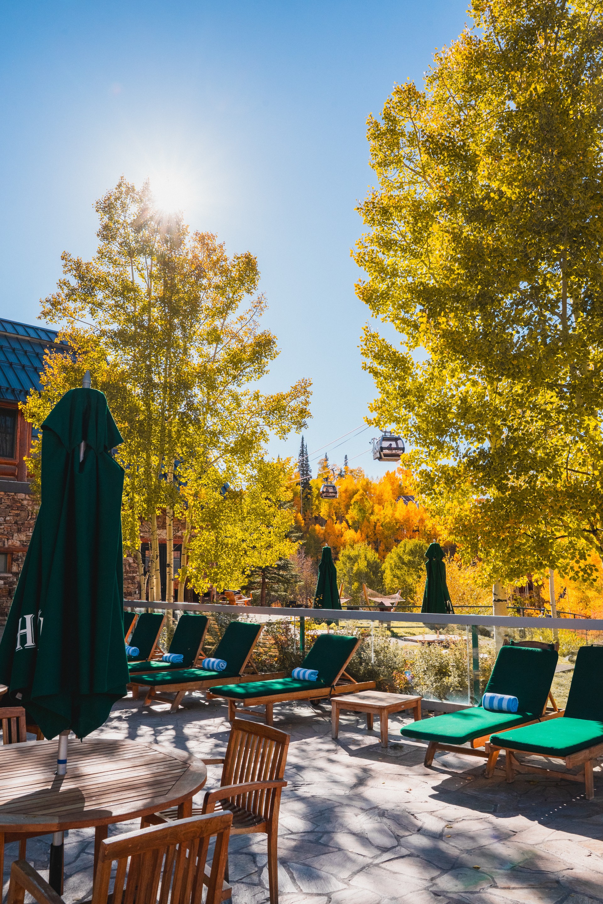 a group of chairs and umbrellas on a patio