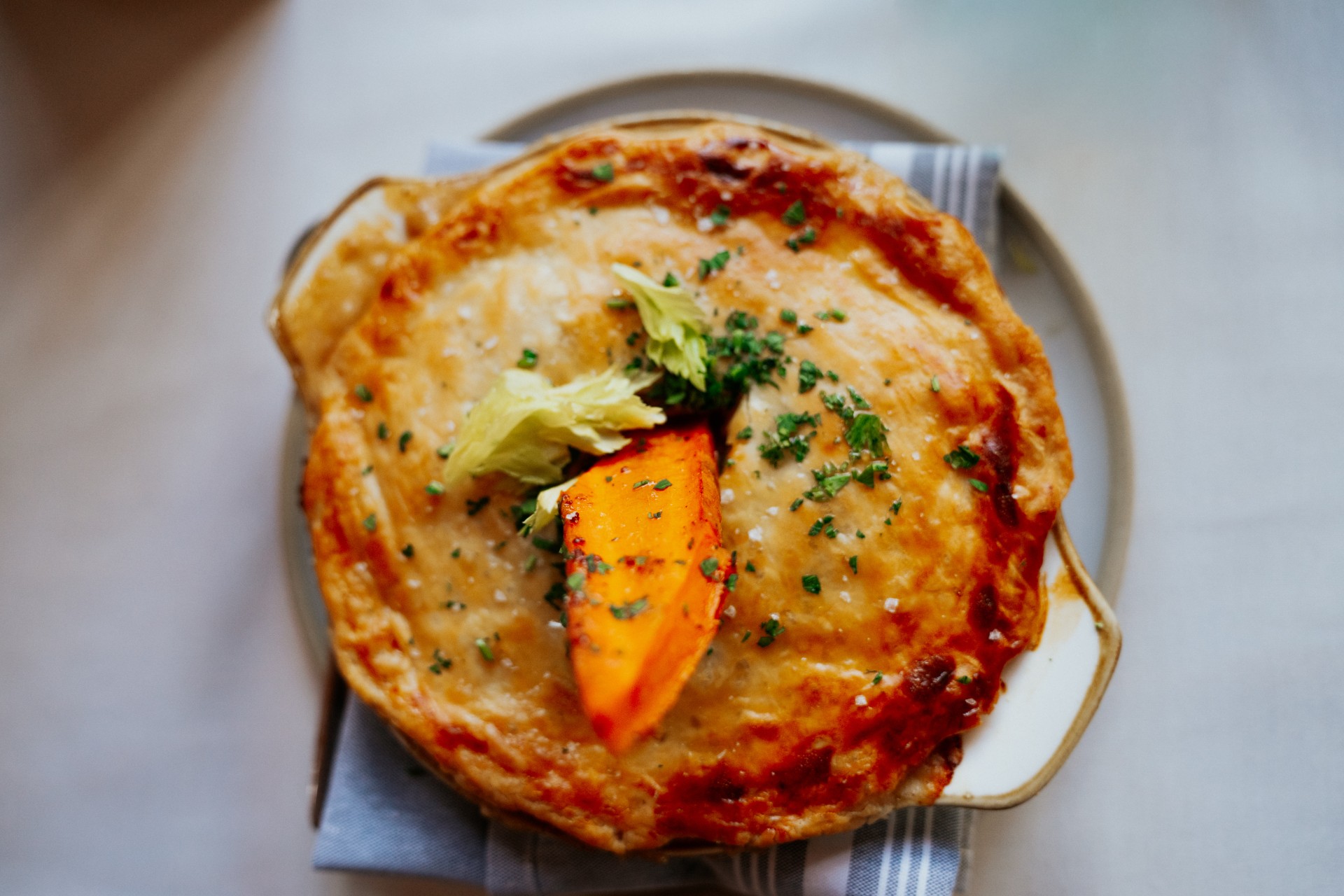 a pie with a piece of vegetable on top