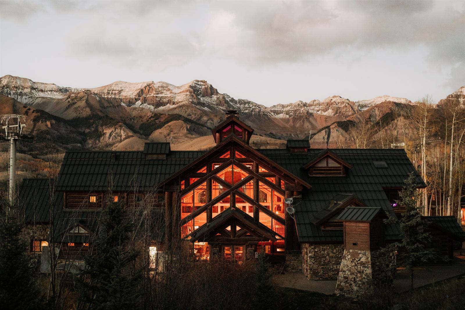 a building with a large window and mountains in the background