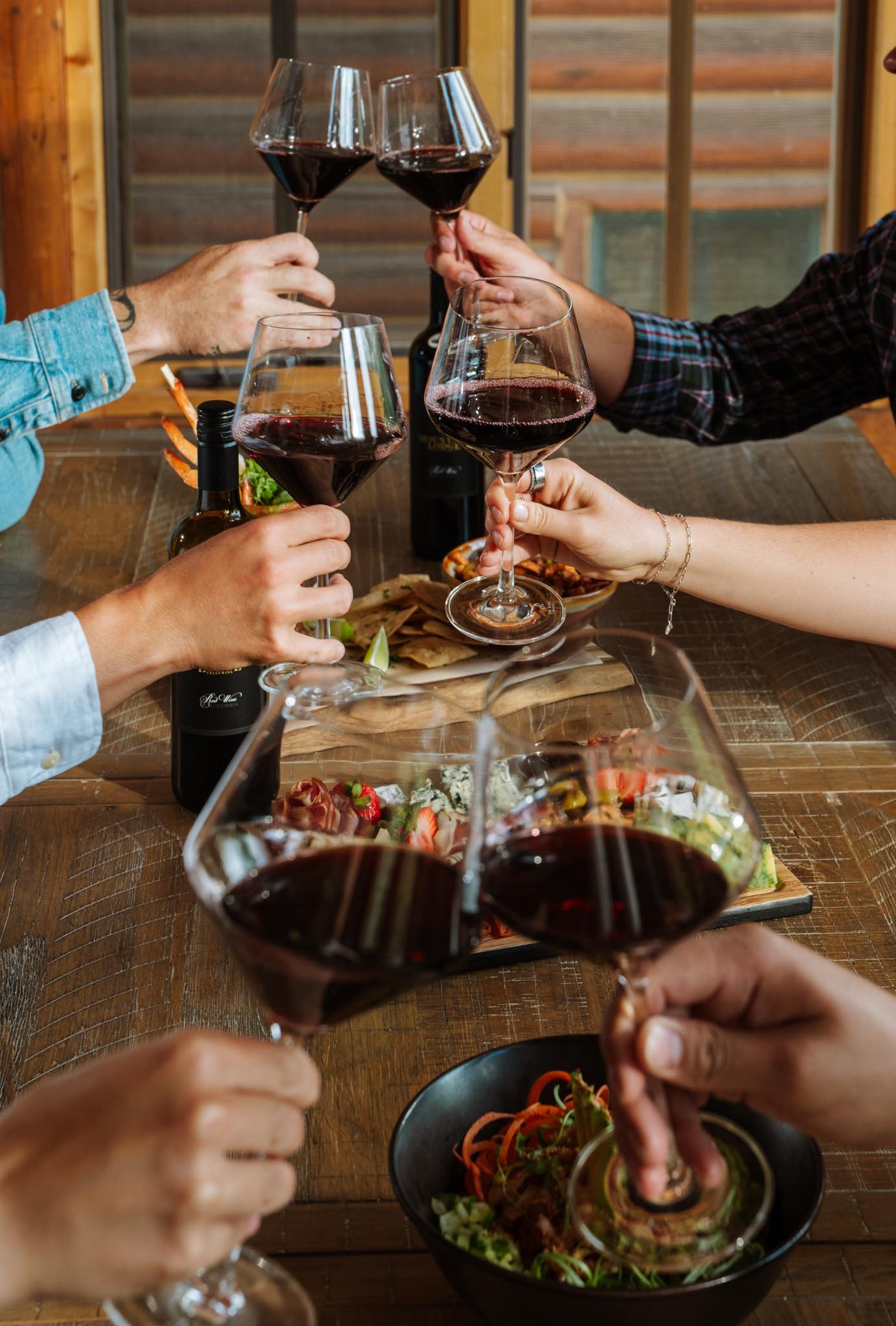 a group of people holding wine glasses