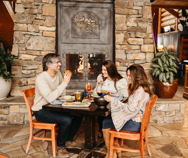 a group of people sitting around a table eating food