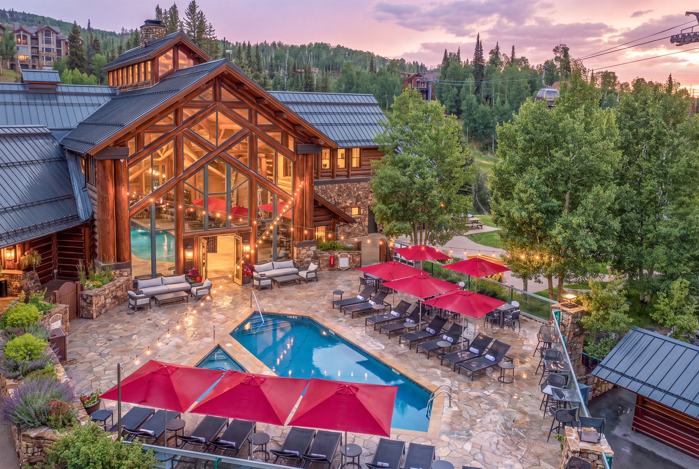 a pool and chairs in front of a house