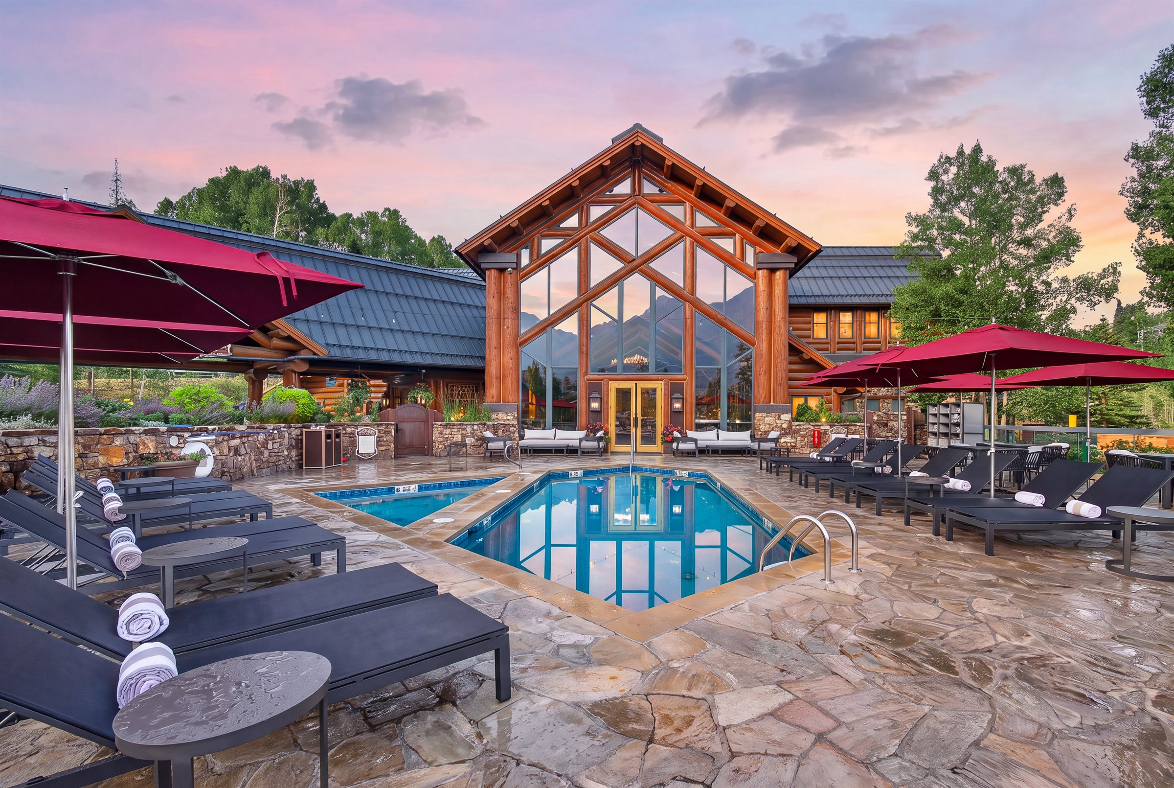 a pool and chairs in front of a building
