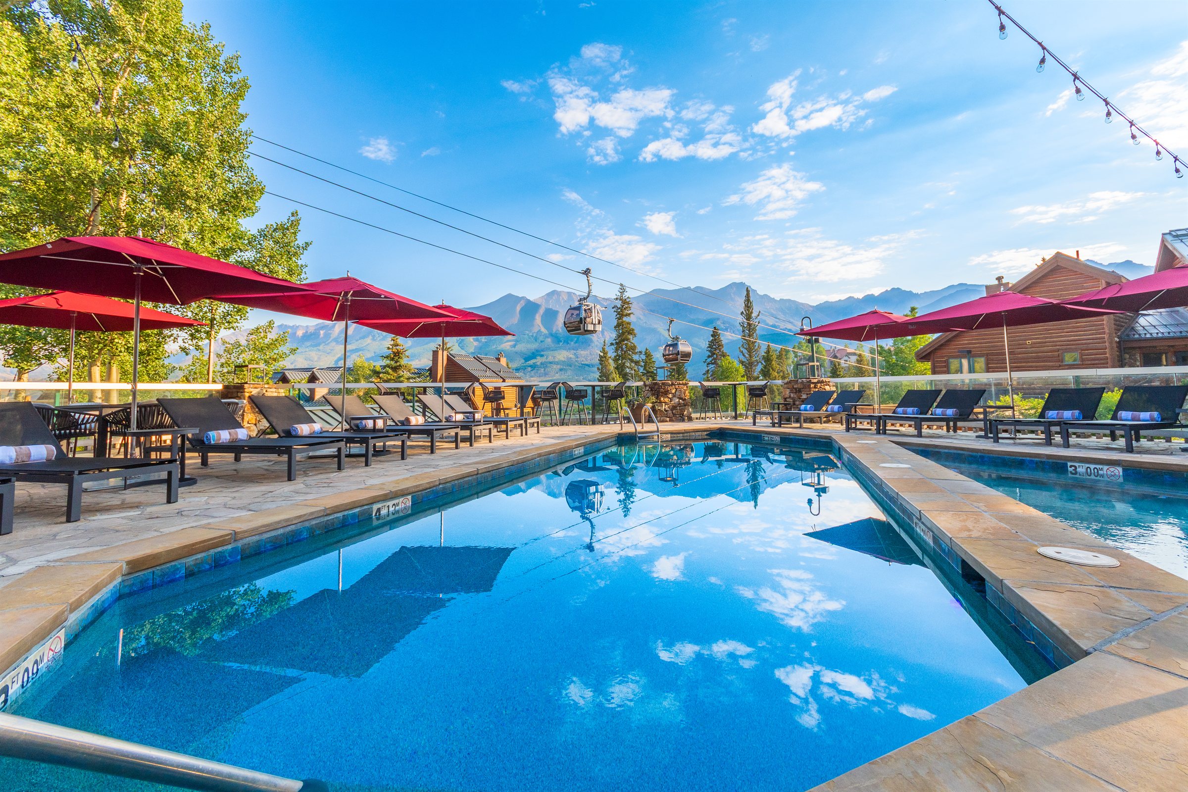 a pool with chairs and umbrellas