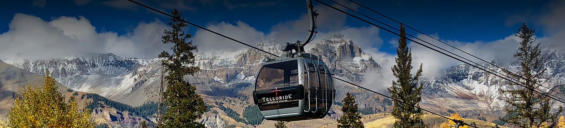 a gondola with mountains in the background