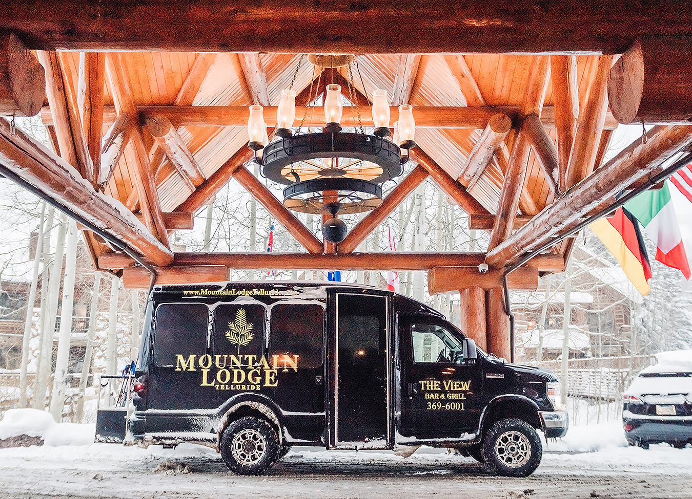 a black van parked under a wooden structure