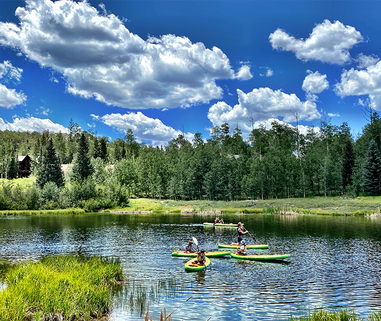 people kayaking on a lake