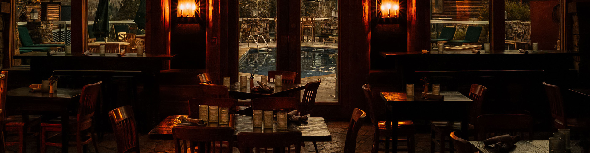 a table and chairs in a room with a pool outside