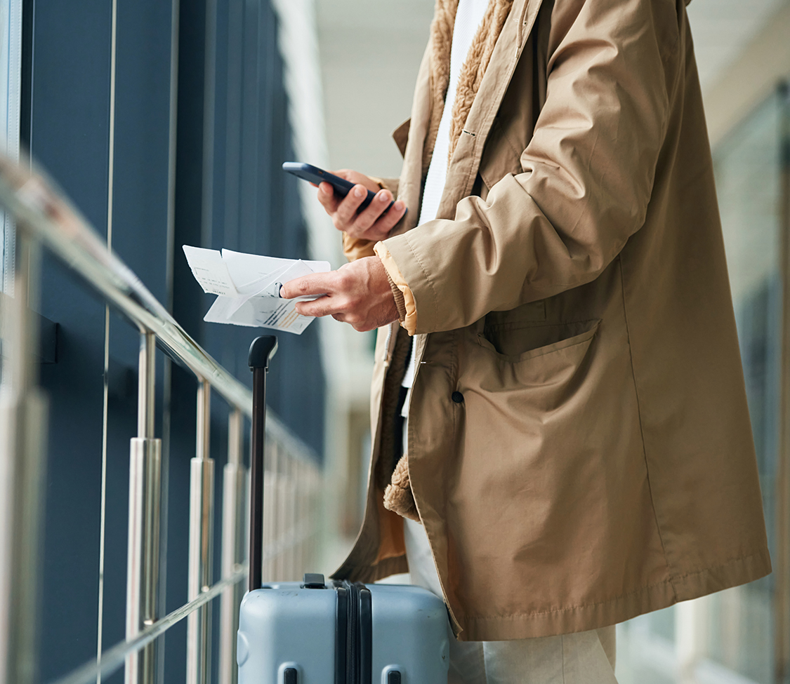 a man holding a piece of paper and a phone