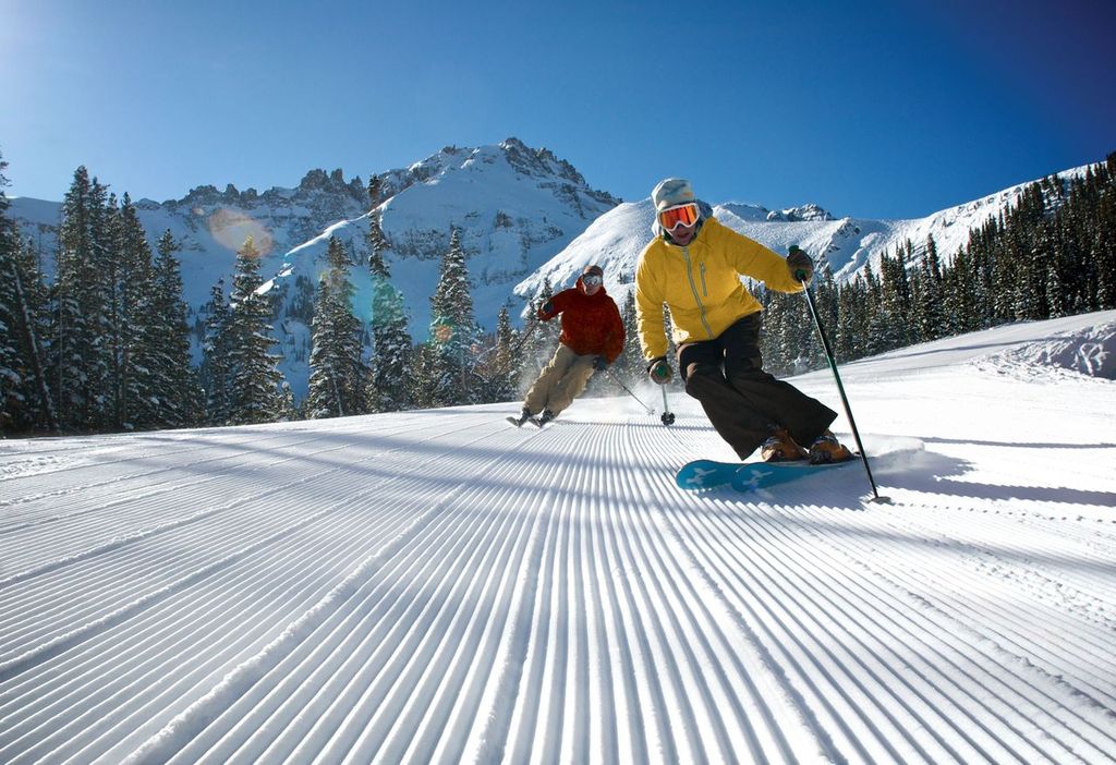 a group of people skiing down a slope