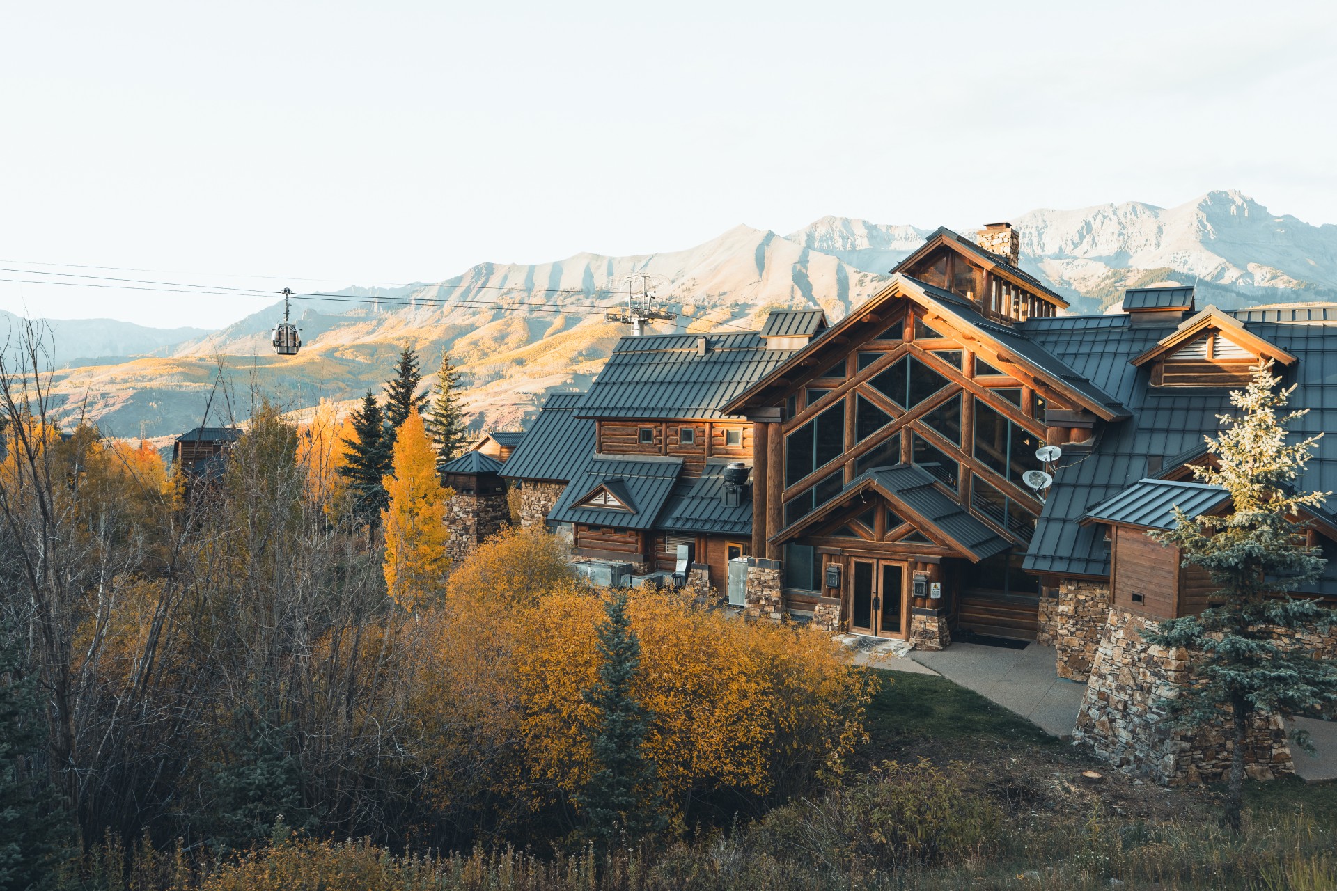 a house with trees and mountains in the background