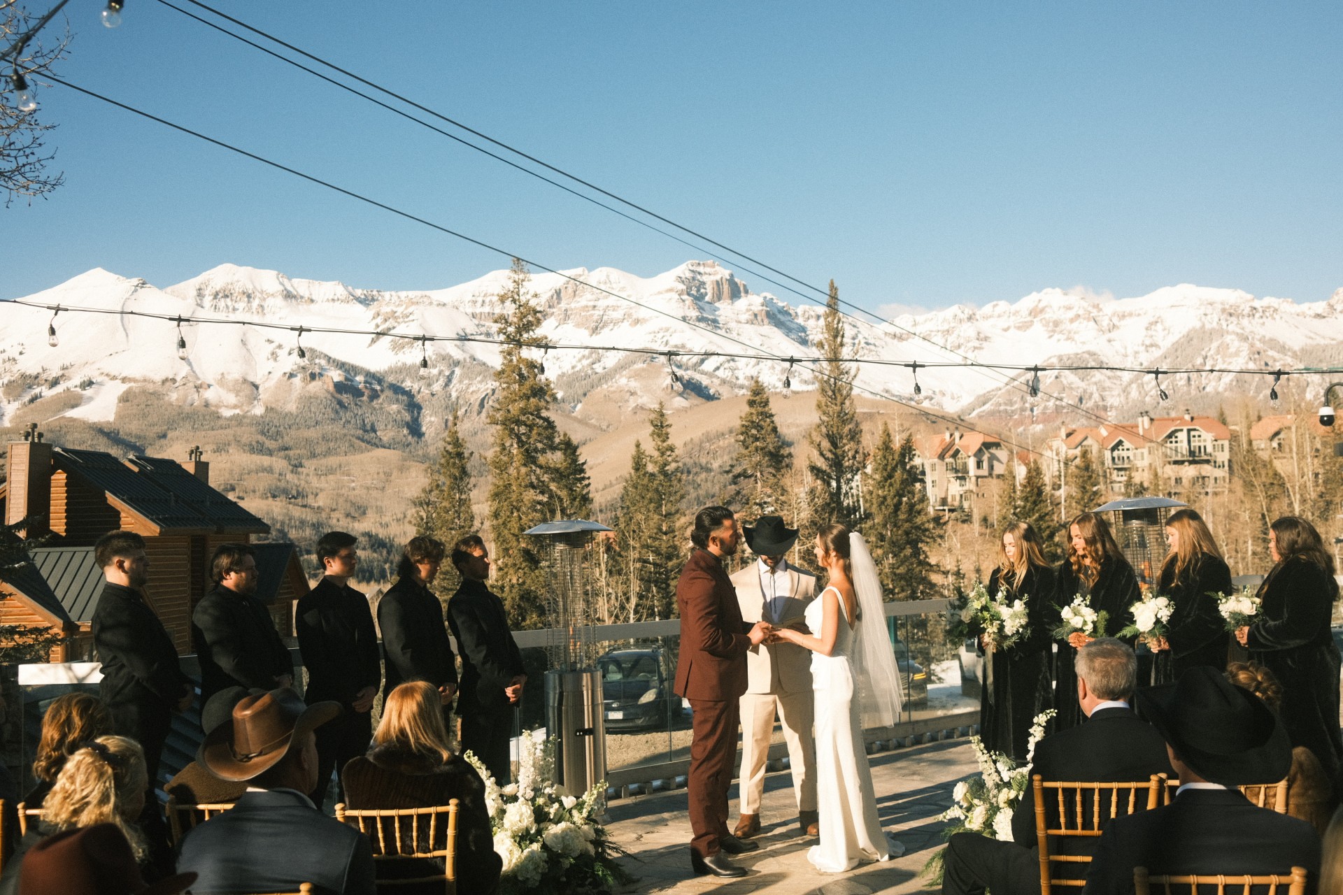 a couple in white dress and a man in a black suit and a woman in a white dress