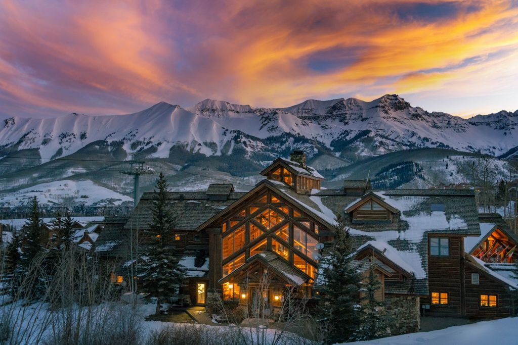 a house with snow on the mountains