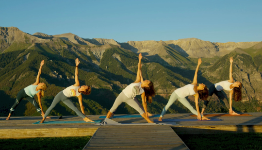 yoga festival with mountains in the background