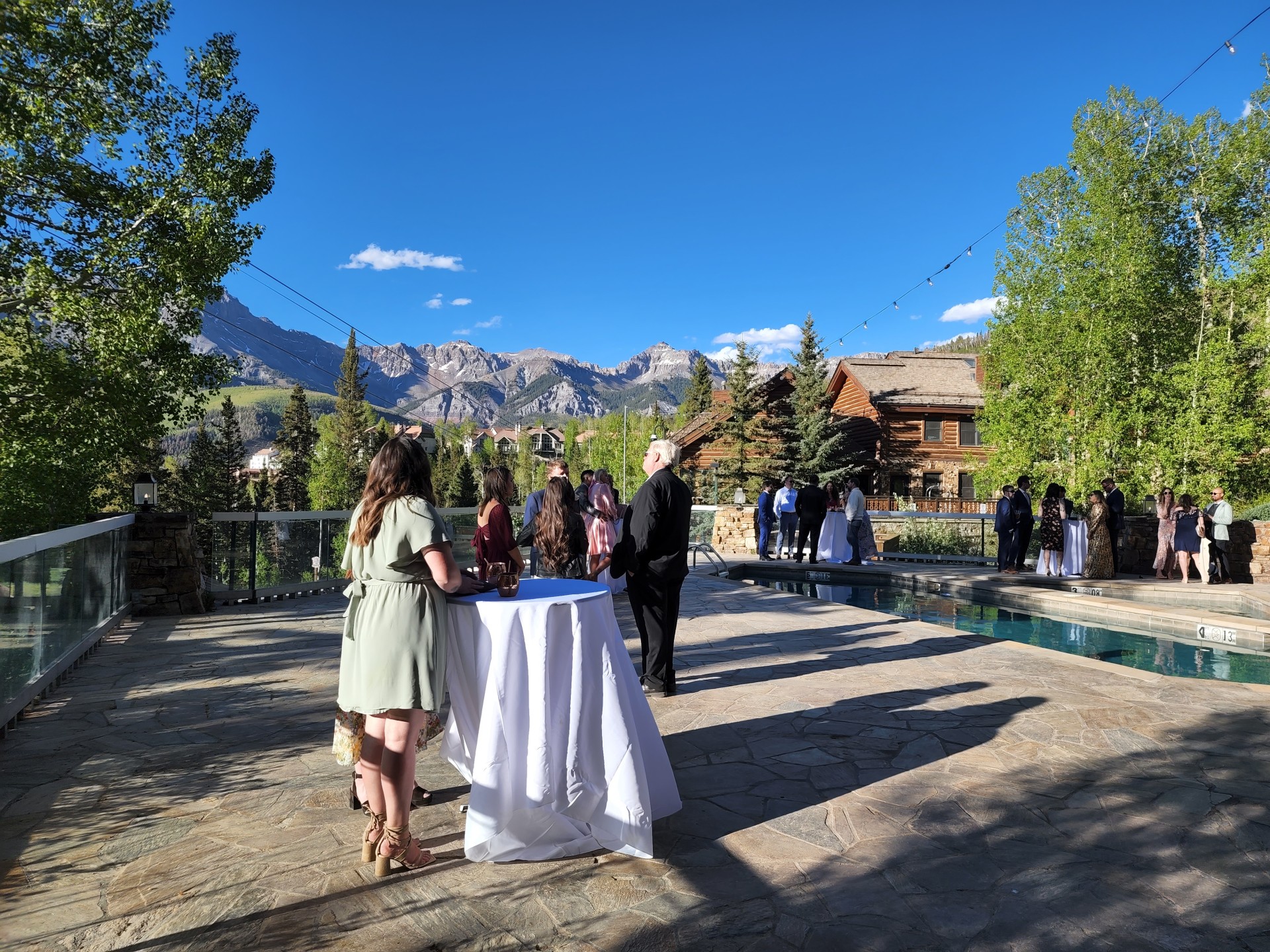 a group of people standing around a table