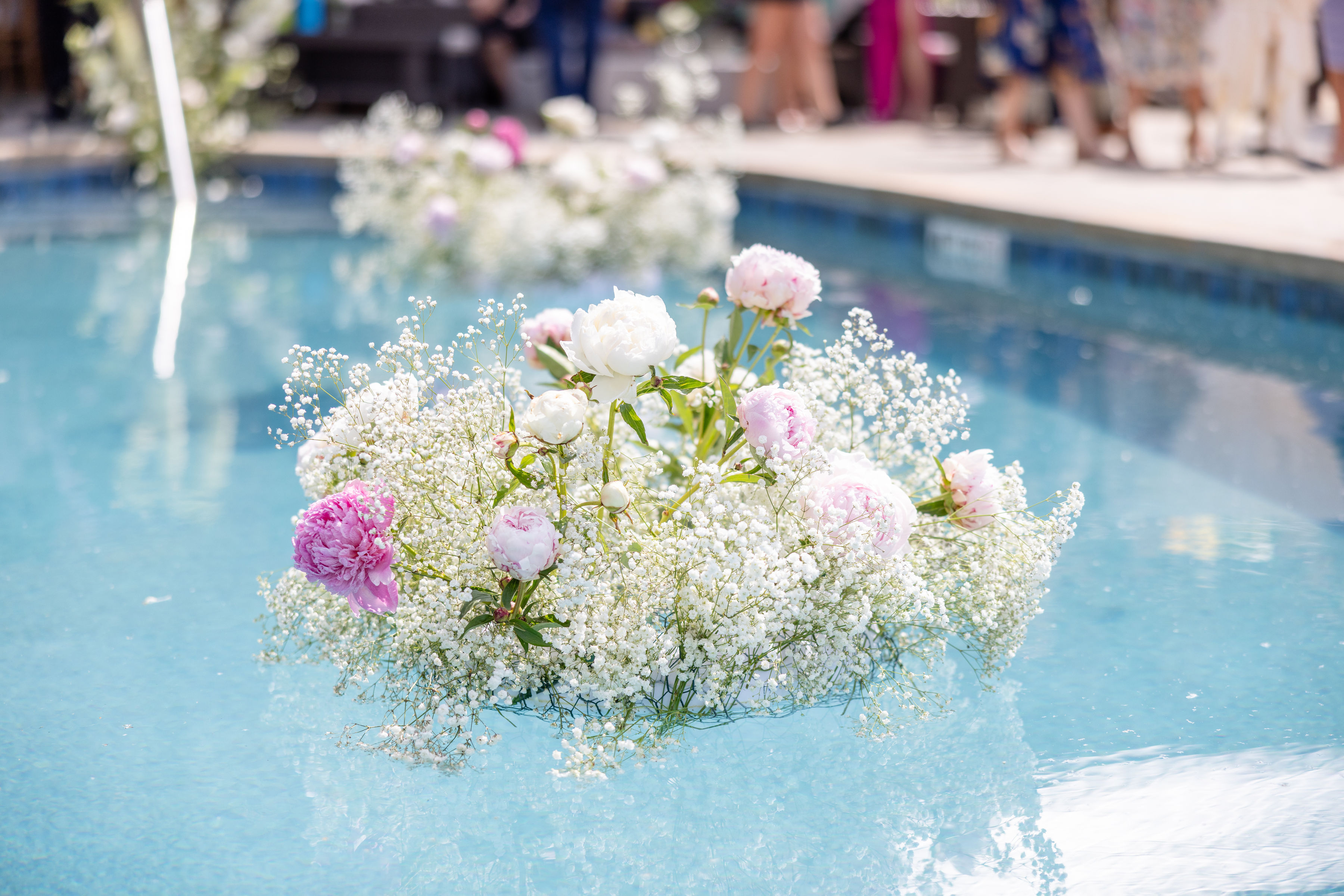 a bouquet of flowers floating in a pool