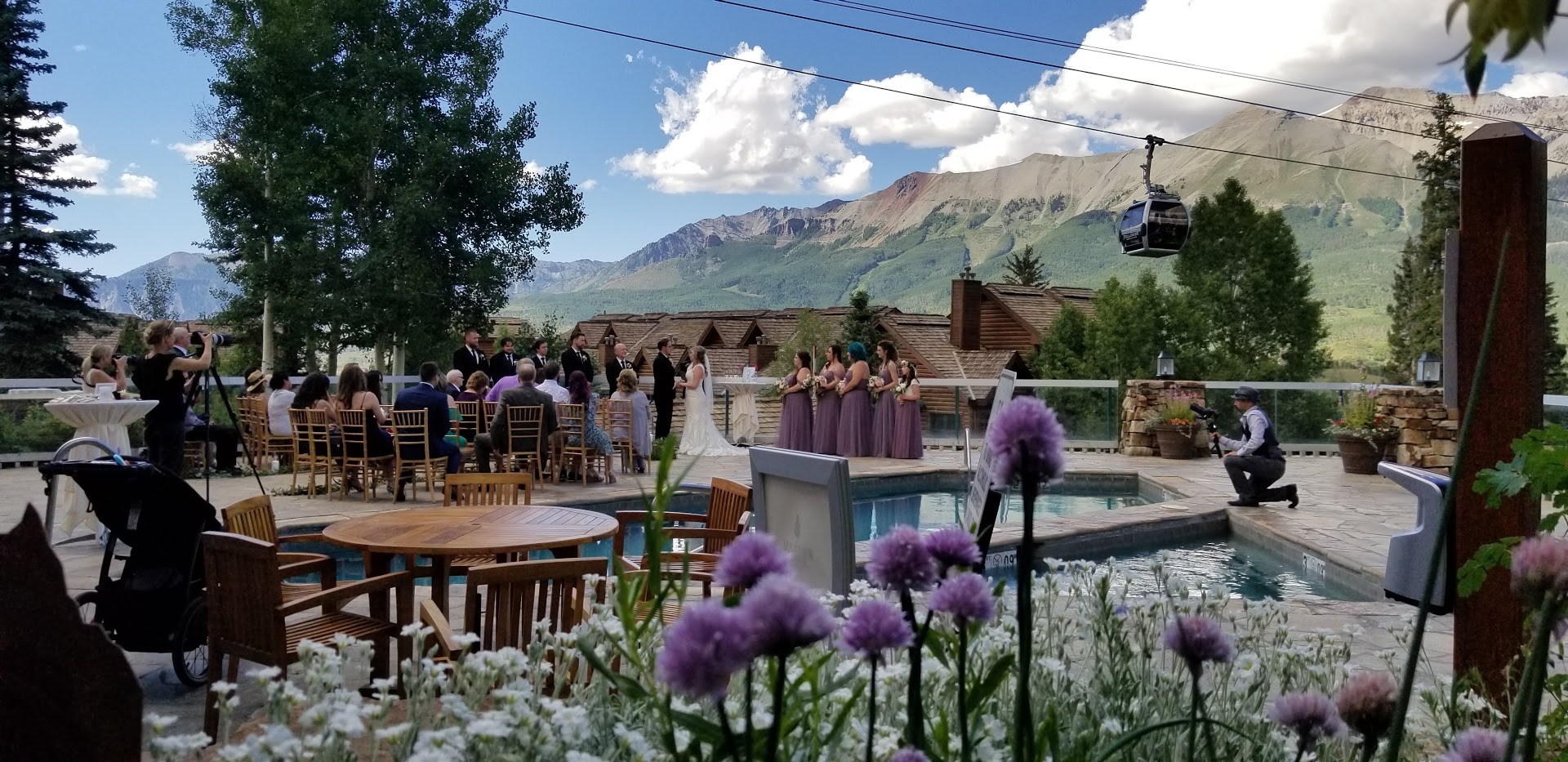 a group of people standing in front of a pool