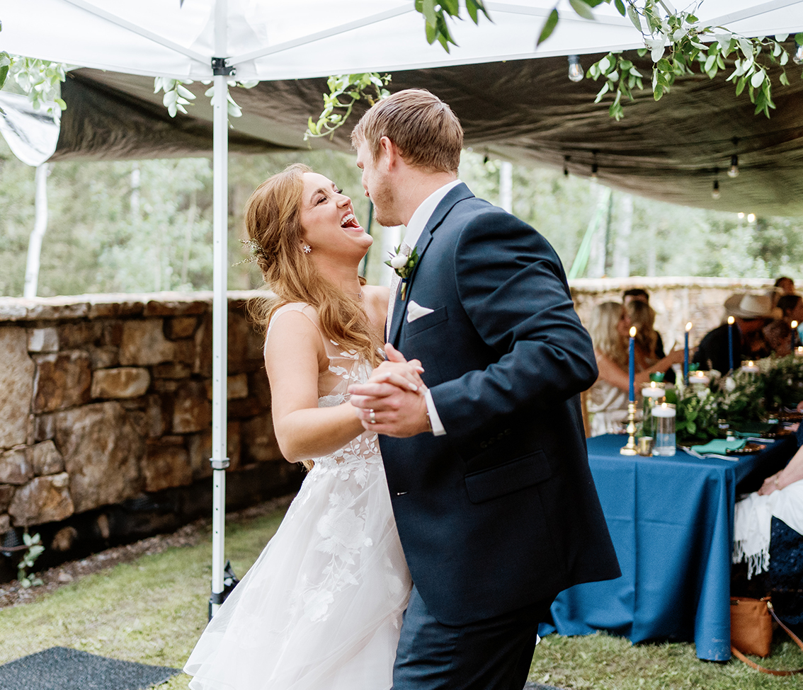 a man and woman kissing under an umbrella