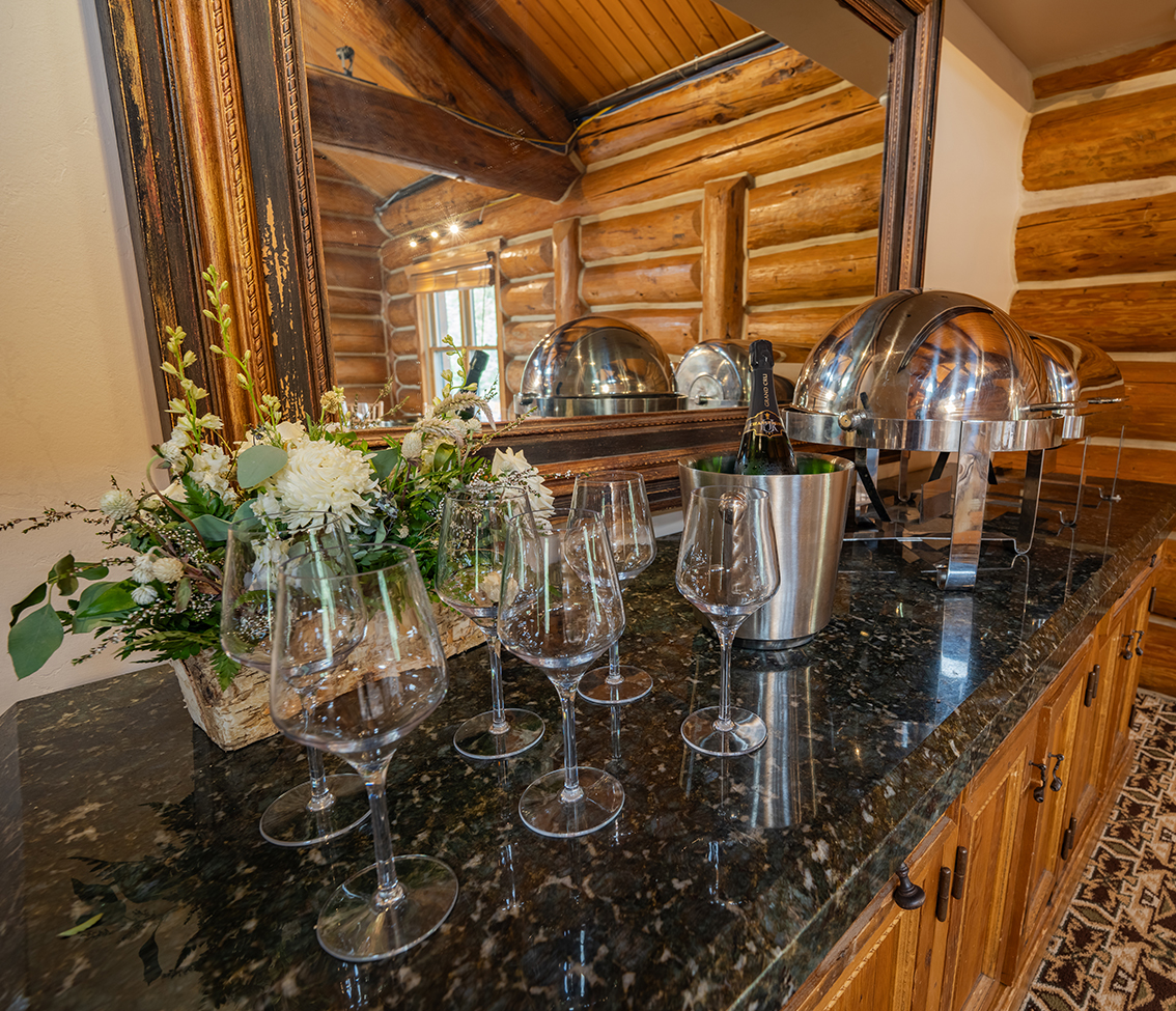 a kitchen counter with wine glasses