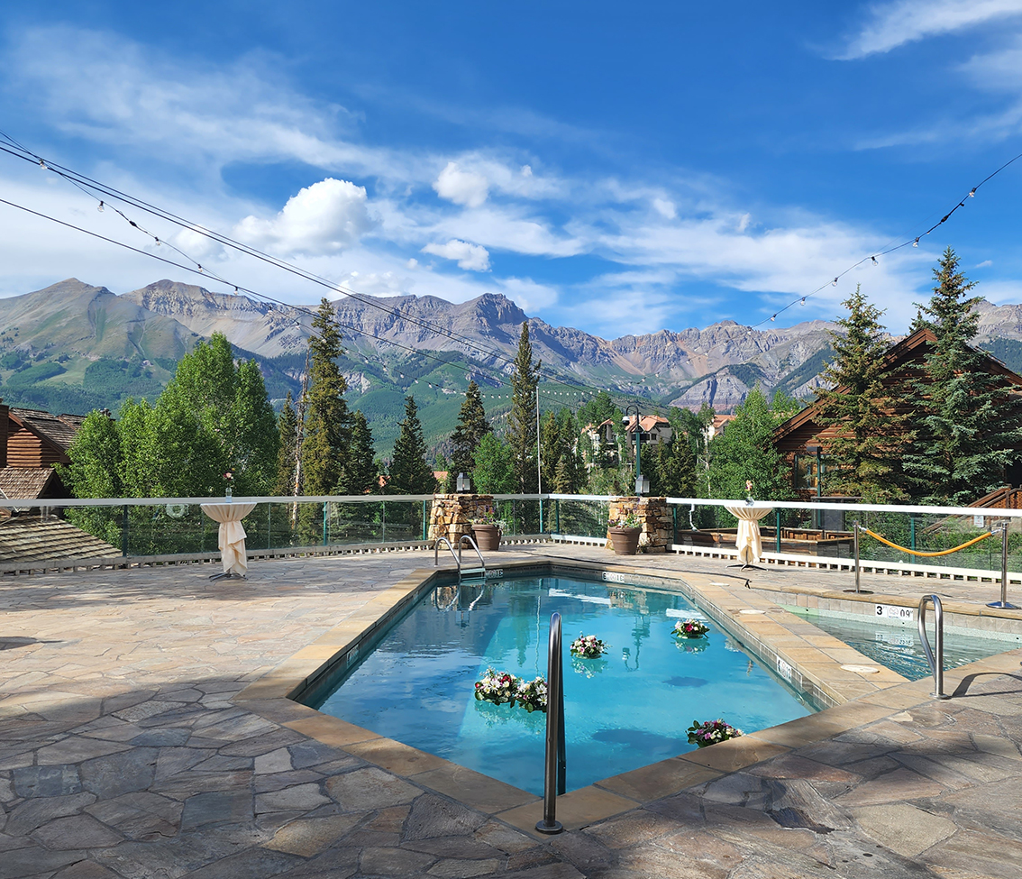 a pool with a mountain in the background