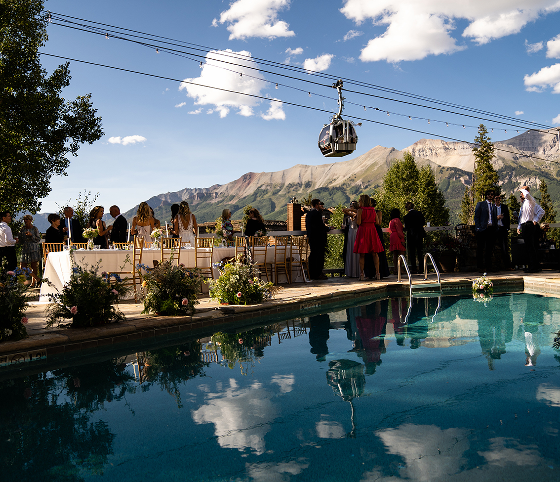 a group of people standing on a dock over a body of water
